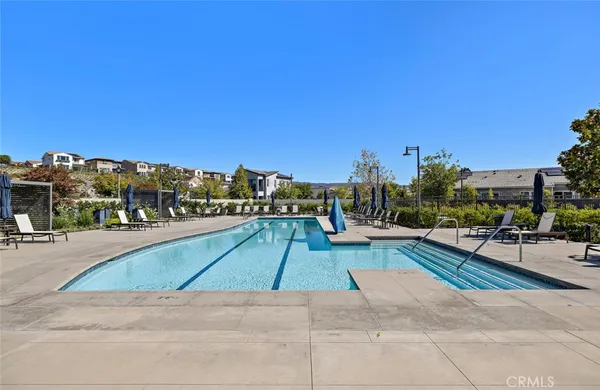 a swimming pool with outdoor seating and yard