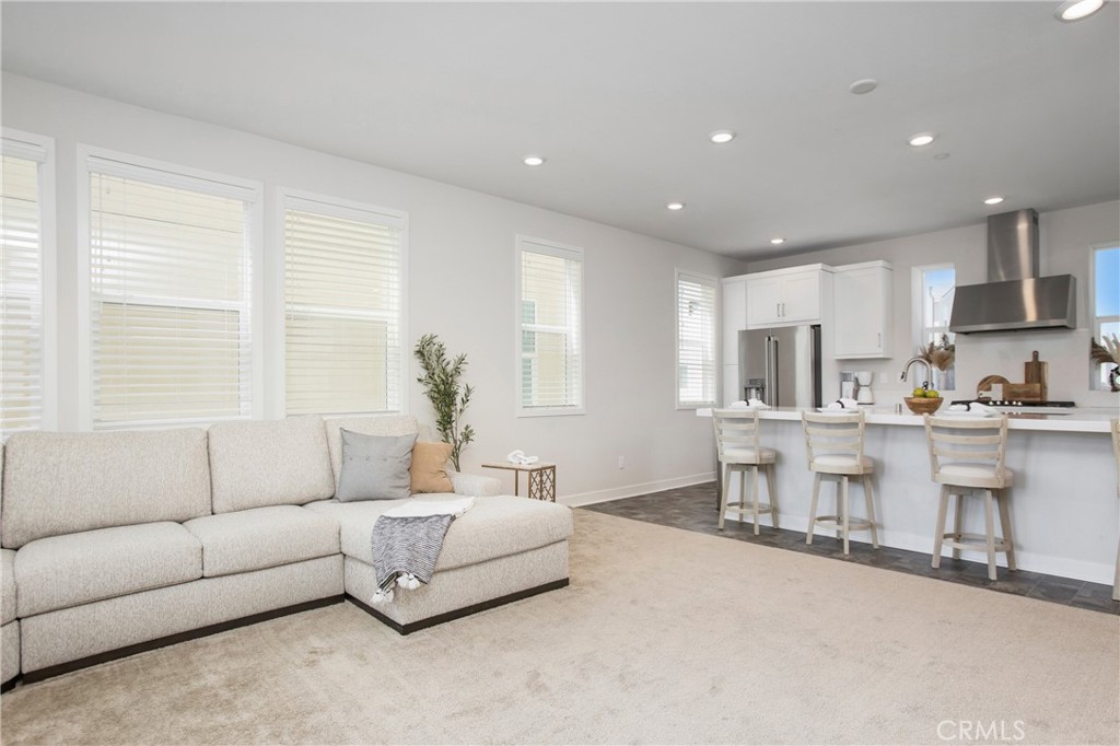 116 Stetson Street Rancho Mission Viejo, CA 92694 - Photo 5 of 45 a living room with furniture and kitchen view