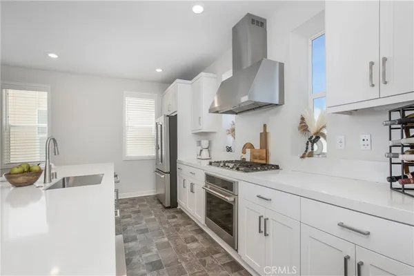 a kitchen with stainless steel appliances a sink stove and refrigerator