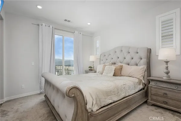 a bedroom with a large bed and a large window