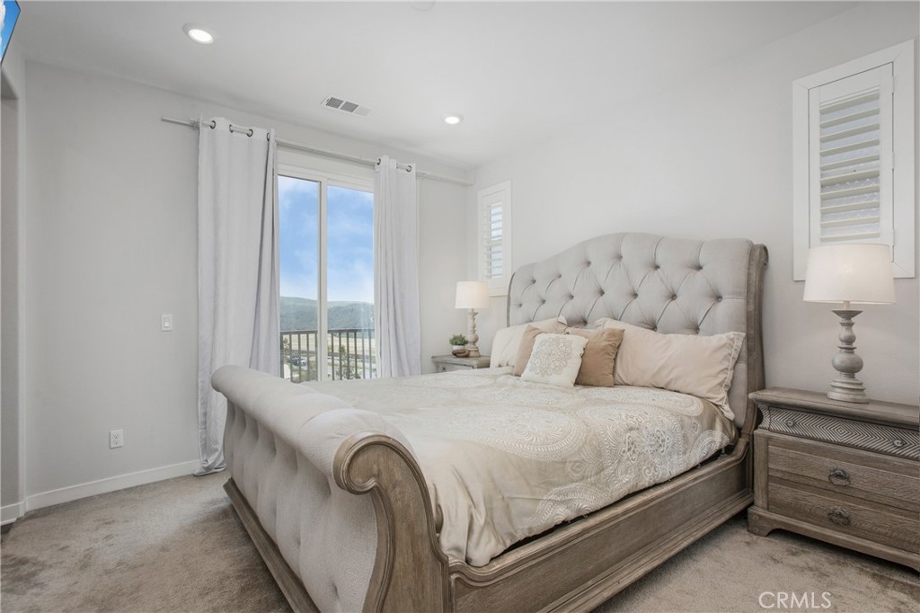 116 Stetson Street Rancho Mission Viejo, CA 92694 - Photo 7 of 45 a bedroom with a large bed and a large window