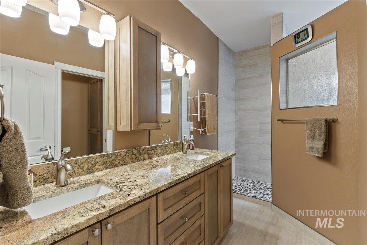 5184 North Greyloch Way Boise, ID 83704 - Photo 14 of 32 Dual vanity with granite countertop, integrated sinks, and brushed nickel fixtures