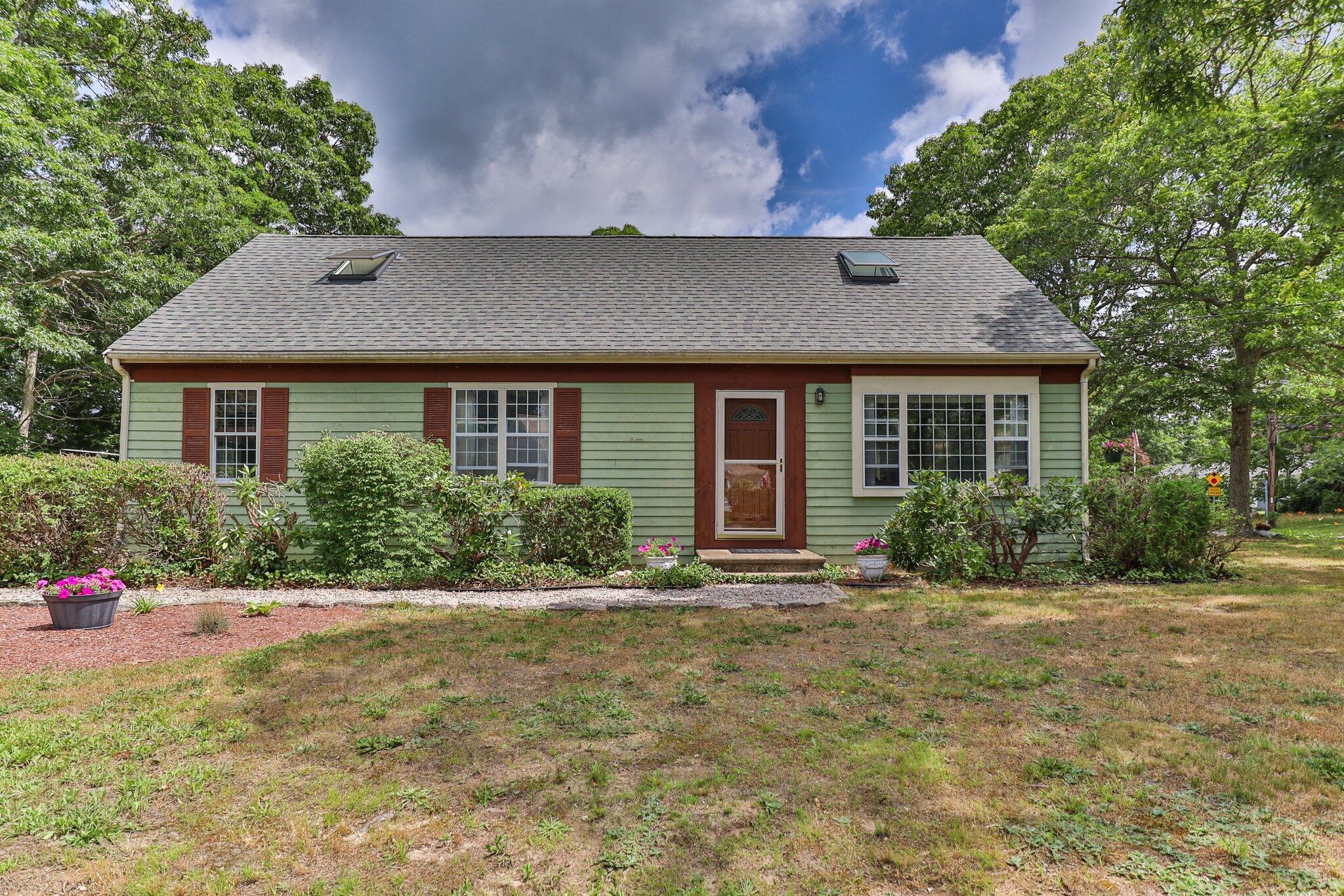 a front view of a house with a yard