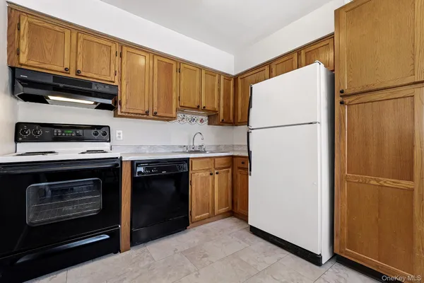 a kitchen with refrigerator a stove a microwave and cabinets