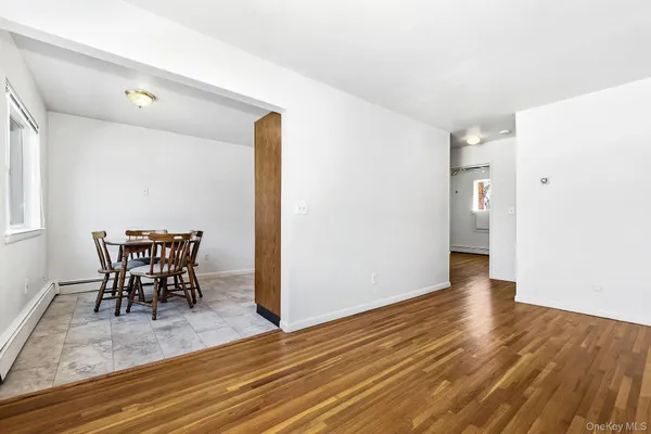 a view of a room with a table and chairs