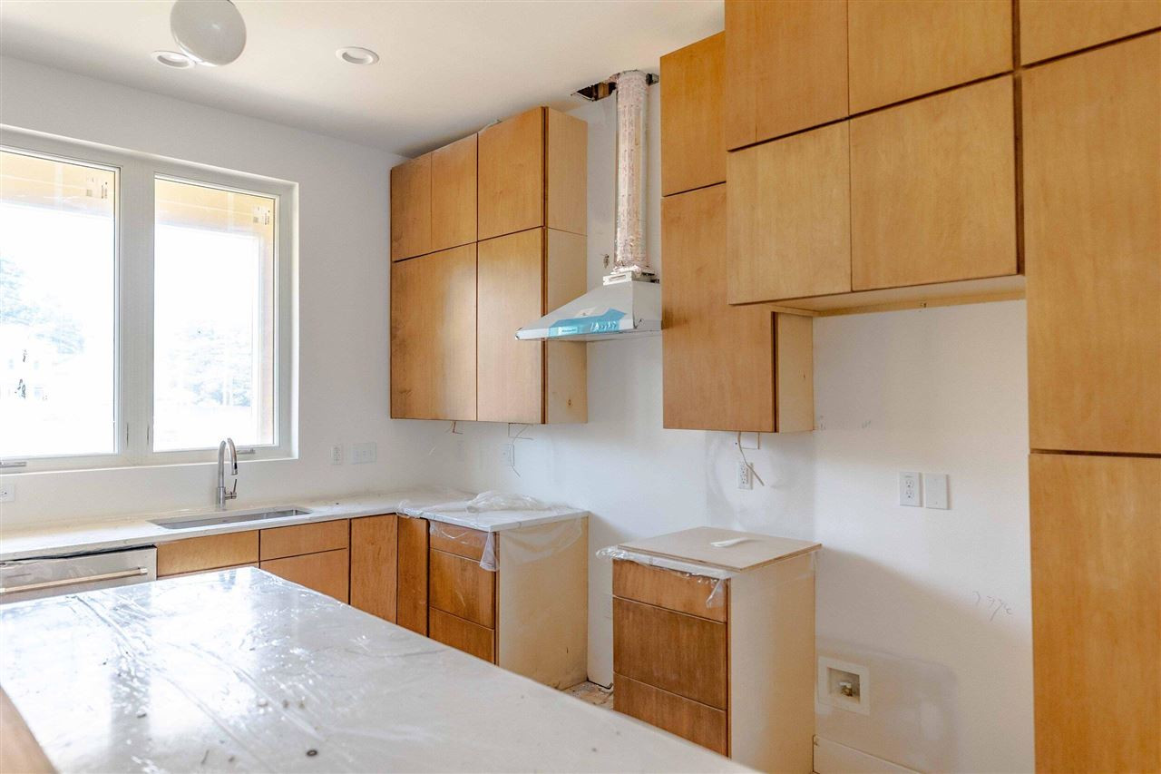 623 North Queen Street Durham, NC 27701 - Photo 10 of 27 a kitchen with stainless steel appliances granite countertop a sink a stove and a refrigerator