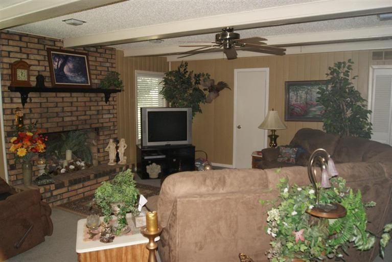 850 Nightingale Road Lubbock, TX 79407 - Photo 8 of 10 a living room with furniture a flat screen tv and a fireplace