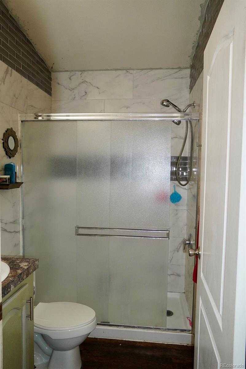 9100 Tejon Street Denver, CO 80260 - Photo 19 of 23 a bathroom with a shower a toilet and a sink