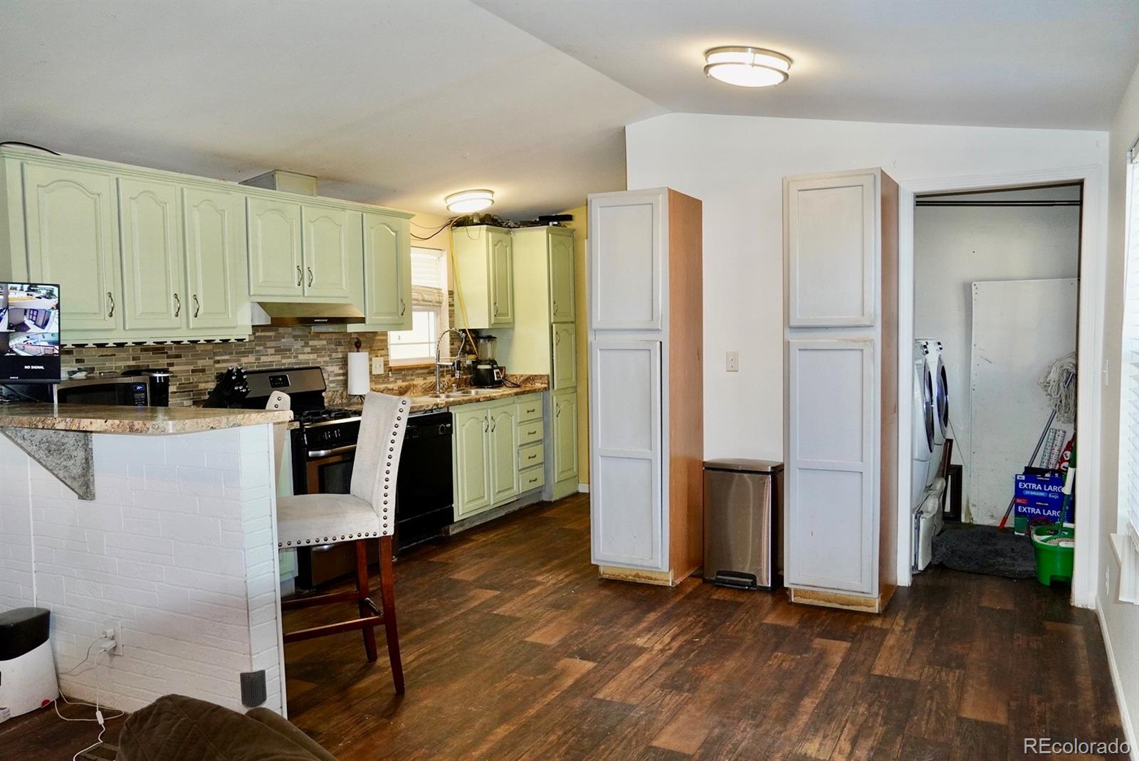9100 Tejon Street Denver, CO 80260 - Photo 8 of 23 a kitchen with stainless steel appliances a stove a sink a refrigerator and cabinets
