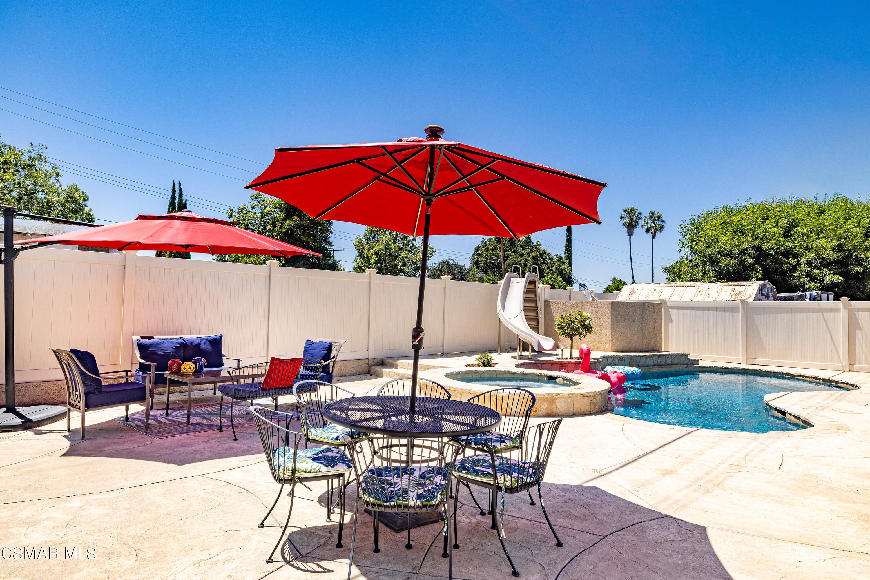973 Appleton Road Simi Valley, CA 93065 - Photo 21 of 24 a view of a patio with a dining table and chairs under an umbrella