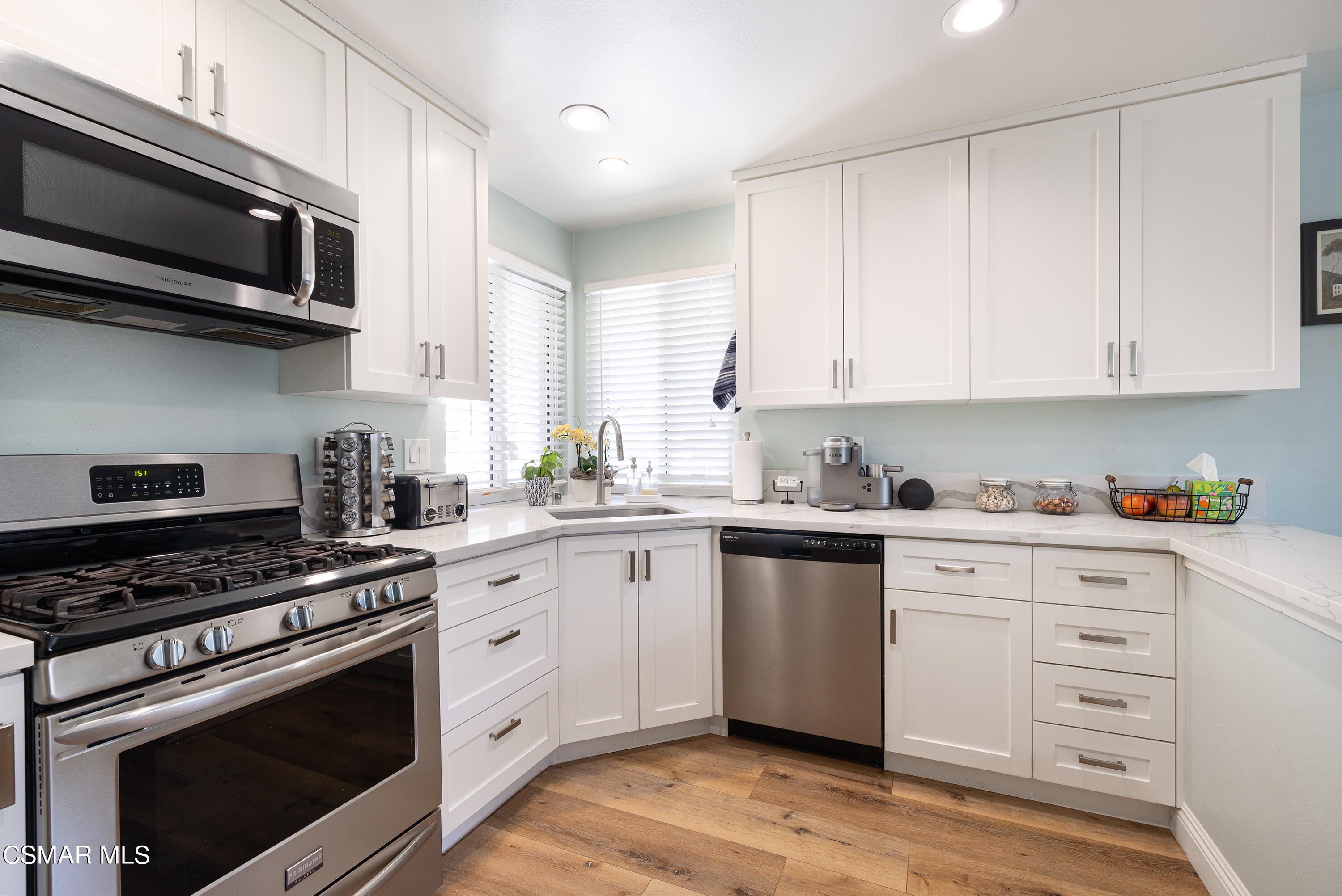 973 Appleton Road Simi Valley, CA 93065 - Photo 10 of 24 a kitchen with stainless steel appliances white cabinets and a stove top oven