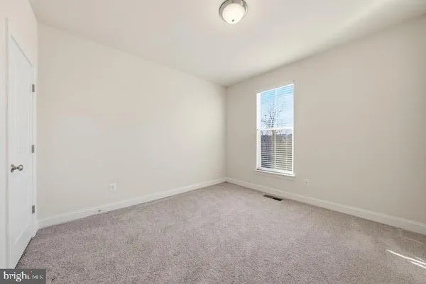 a view of walk in closet with clothes