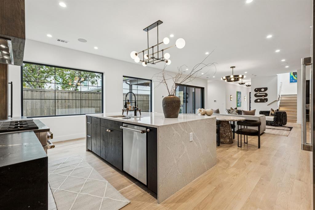 7707 Robin Road Dallas, TX 75209 - Photo 12 of 40 a kitchen with counter space dining table and chairs