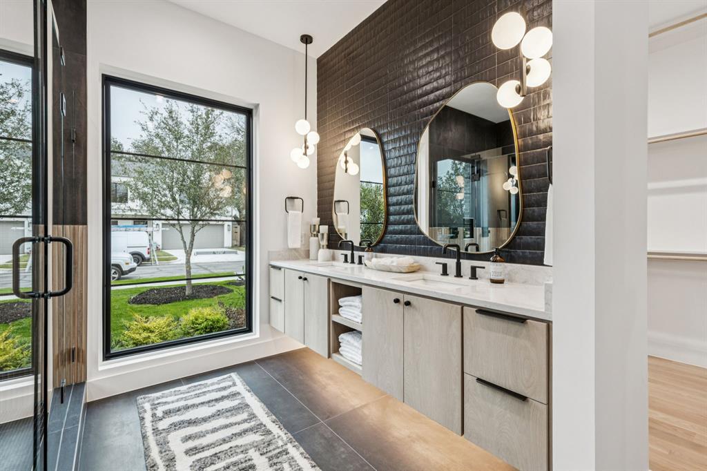 7707 Robin Road Dallas, TX 75209 - Photo 16 of 40 a bathroom with a double vanity sink and a mirror