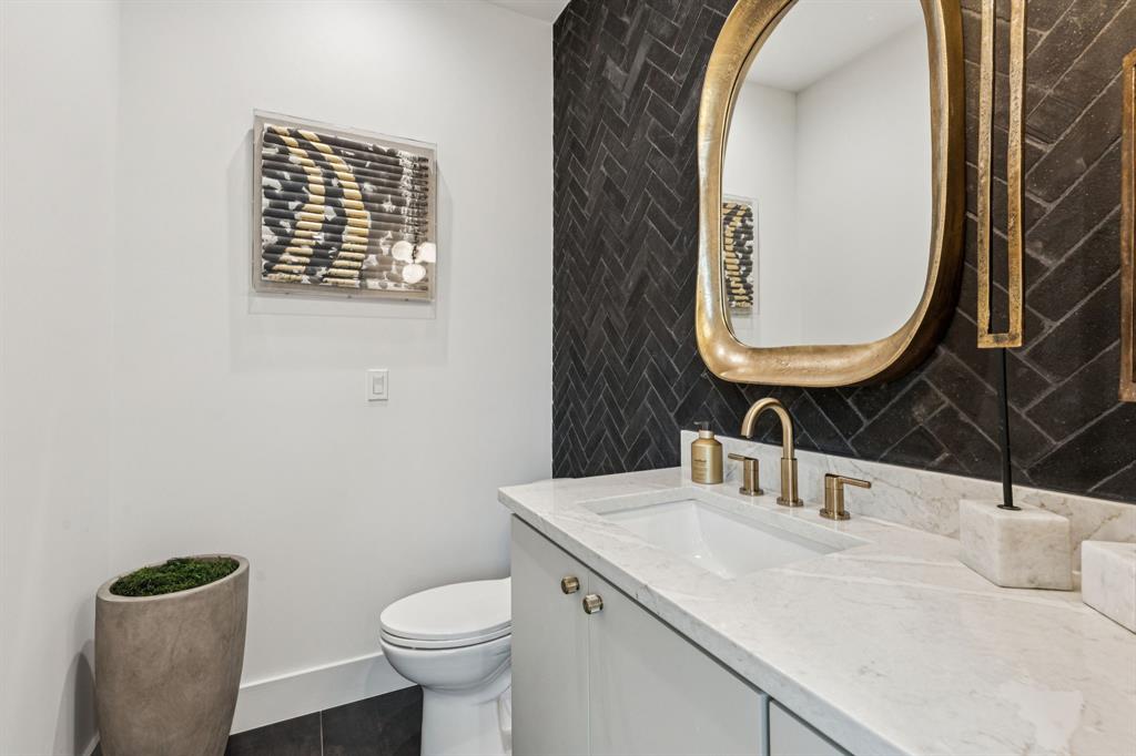 7707 Robin Road Dallas, TX 75209 - Photo 21 of 40 a bathroom with a toilet sink and mirror