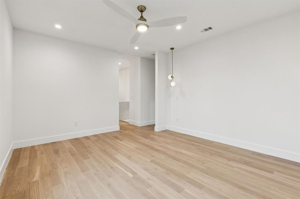 7707 Robin Road Dallas, TX 75209 - Photo 22 of 40 an empty room with wooden floor and windows