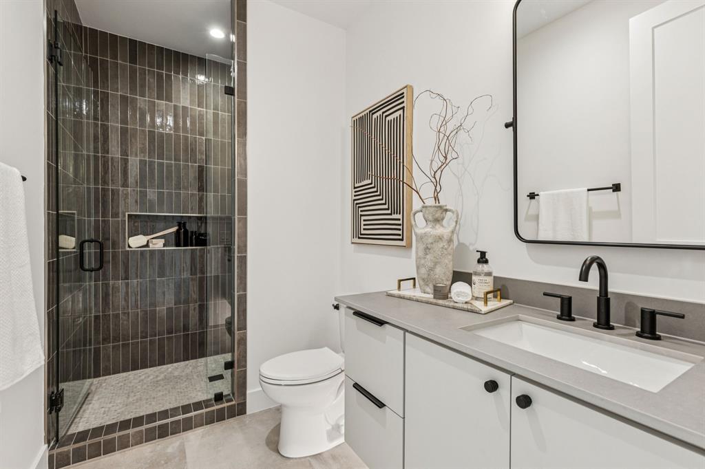 7707 Robin Road Dallas, TX 75209 - Photo 30 of 40 a bathroom with a sink a toilet and shower