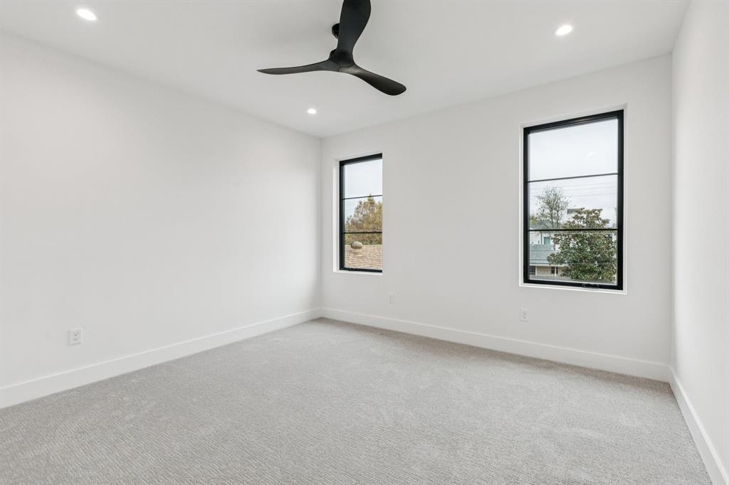7707 Robin Road Dallas, TX 75209 - Photo 31 of 40 an empty room with windows and fan