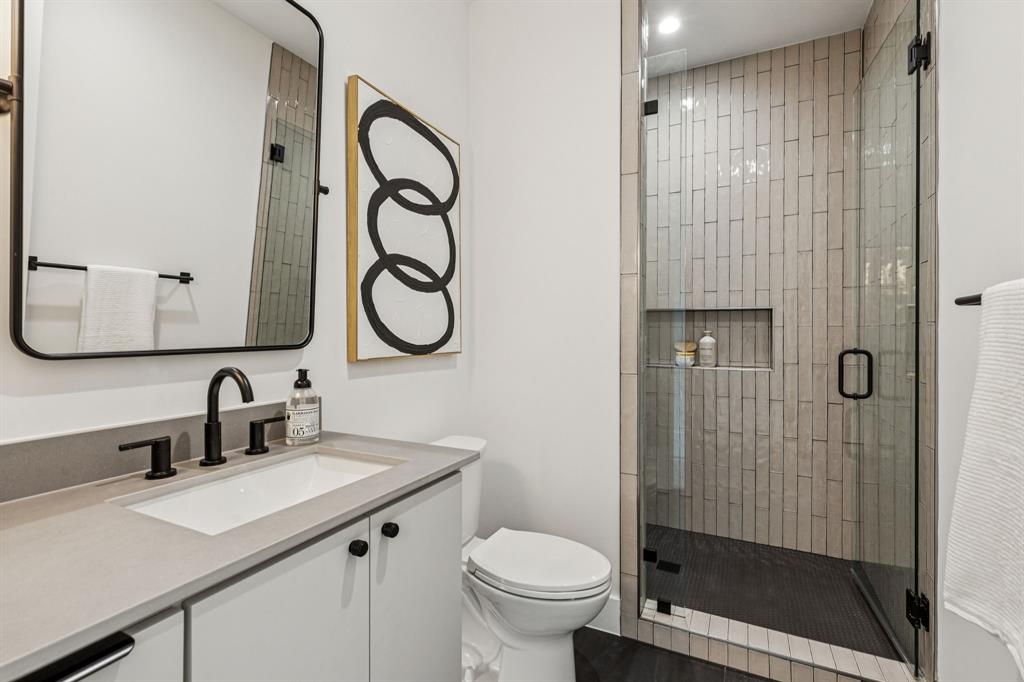 7707 Robin Road Dallas, TX 75209 - Photo 32 of 40 a bathroom with a sink a toilet and shower