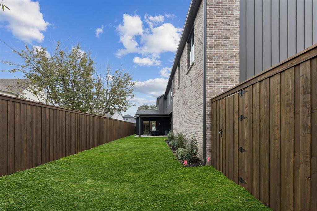 7707 Robin Road Dallas, TX 75209 - Photo 39 of 40 a view of a backyard with potted plants and wooden fence