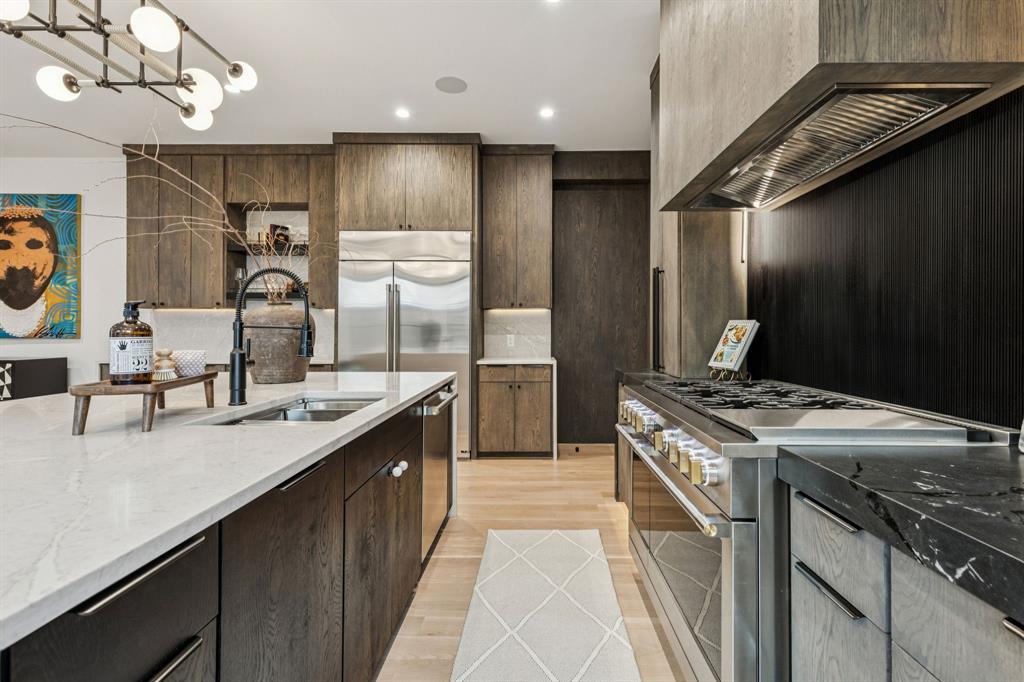 7707 Robin Road Dallas, TX 75209 - Photo 9 of 40 a kitchen with kitchen island granite countertop a sink stainless steel appliances and cabinets
