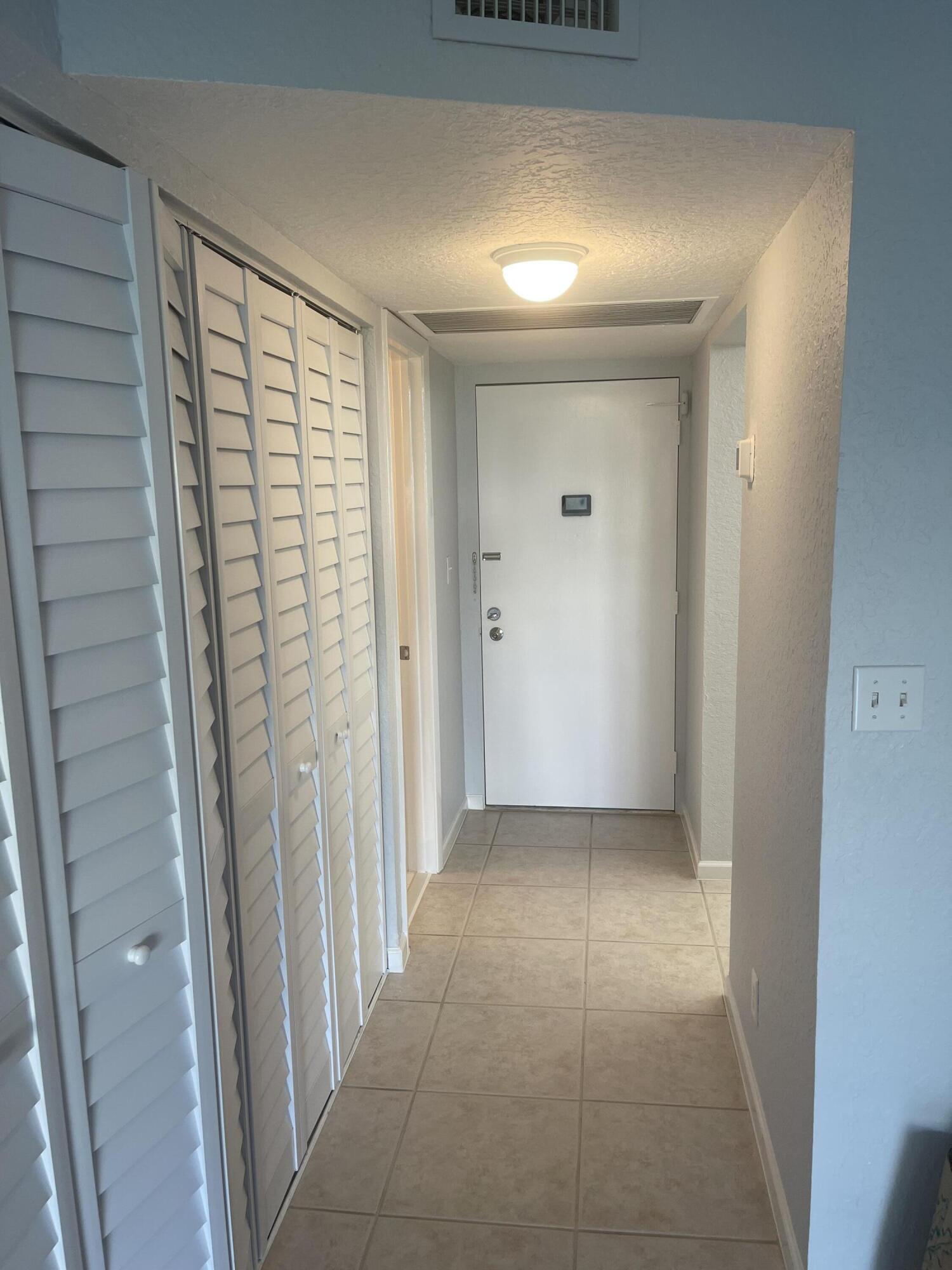 9273 Southwest 8th Street, Unit 116 Boca Raton, FL 33428 - Photo 3 of 15 Front Door - Hallway