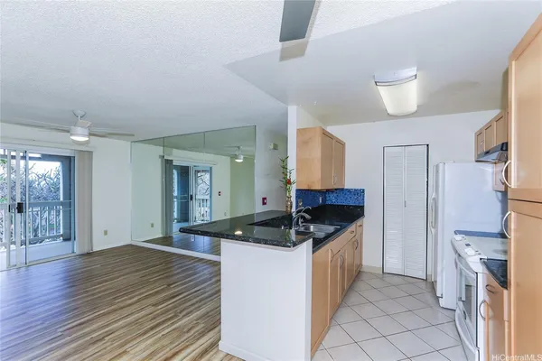 a kitchen with a sink stove and refrigerator