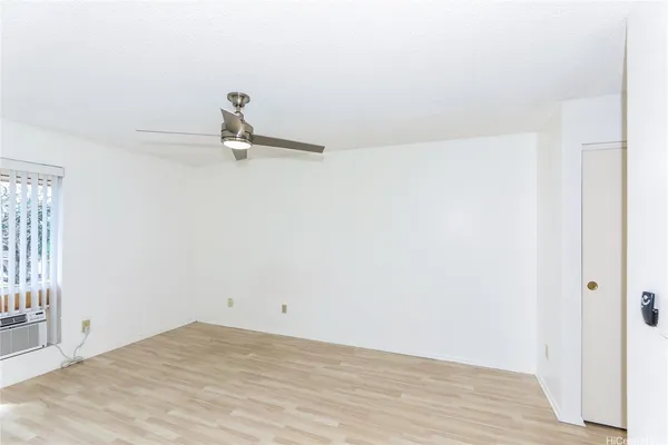 a view of a room with wooden floor and window