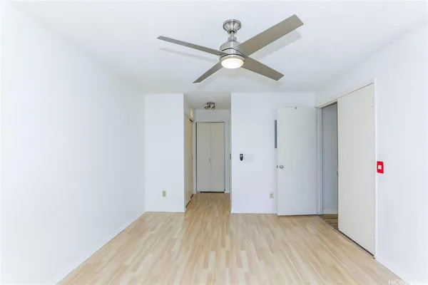 a view of an empty room and wooden floor