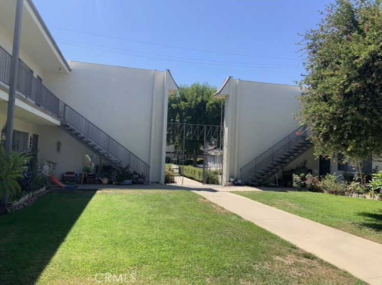425 Fairview Avenue, Unit 27 Arcadia, CA 91007 - Photo 6 of 6 a view of a house with a yard and potted plants