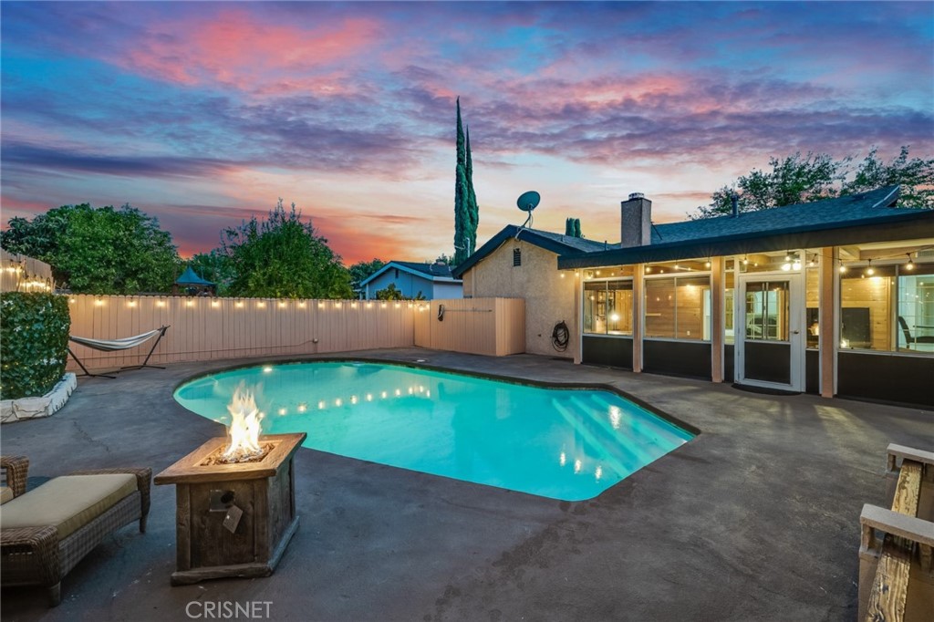 swimming pool view with a outdoor seating space