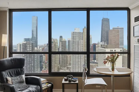 a view of a balcony with furniture and floor to ceiling window