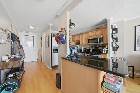 a kitchen that has a lot of cabinets and refrigerator