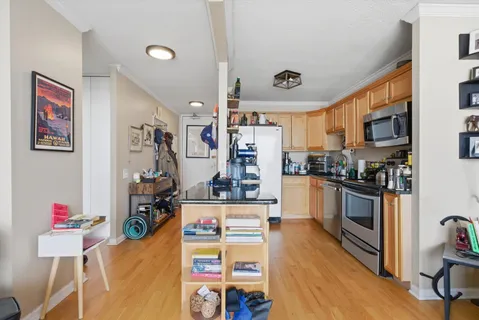 a kitchen with a refrigerator and a stove top oven