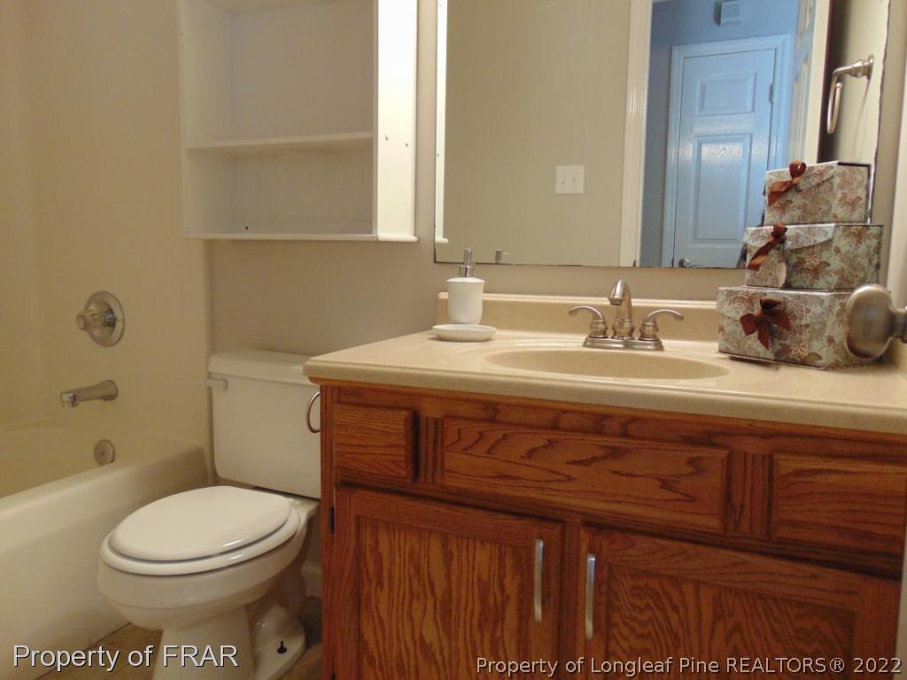 5313 Harding Drive Hope Mills, NC 28348 - Photo 11 of 26 a bathroom with a sink a toilet and shower