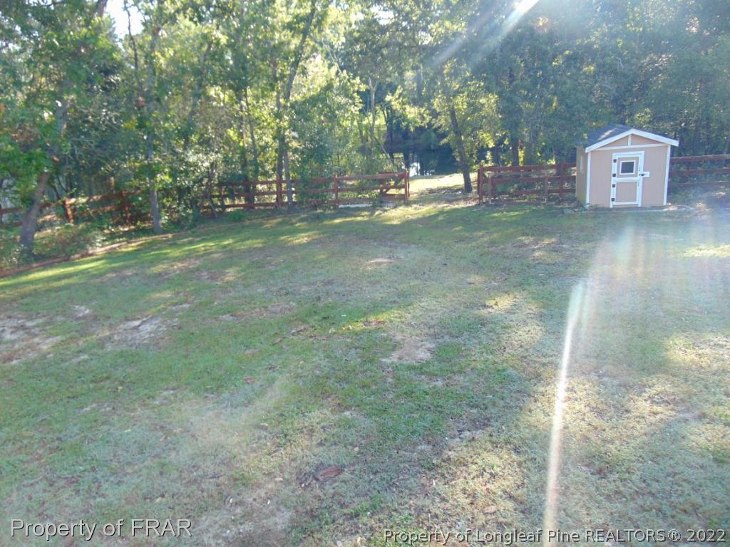 5313 Harding Drive Hope Mills, NC 28348 - Photo 17 of 26 a backyard of a house with table and chairs