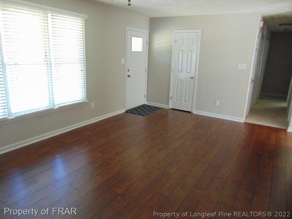 5313 Harding Drive Hope Mills, NC 28348 - Photo 5 of 26 an empty room with wooden floor and windows