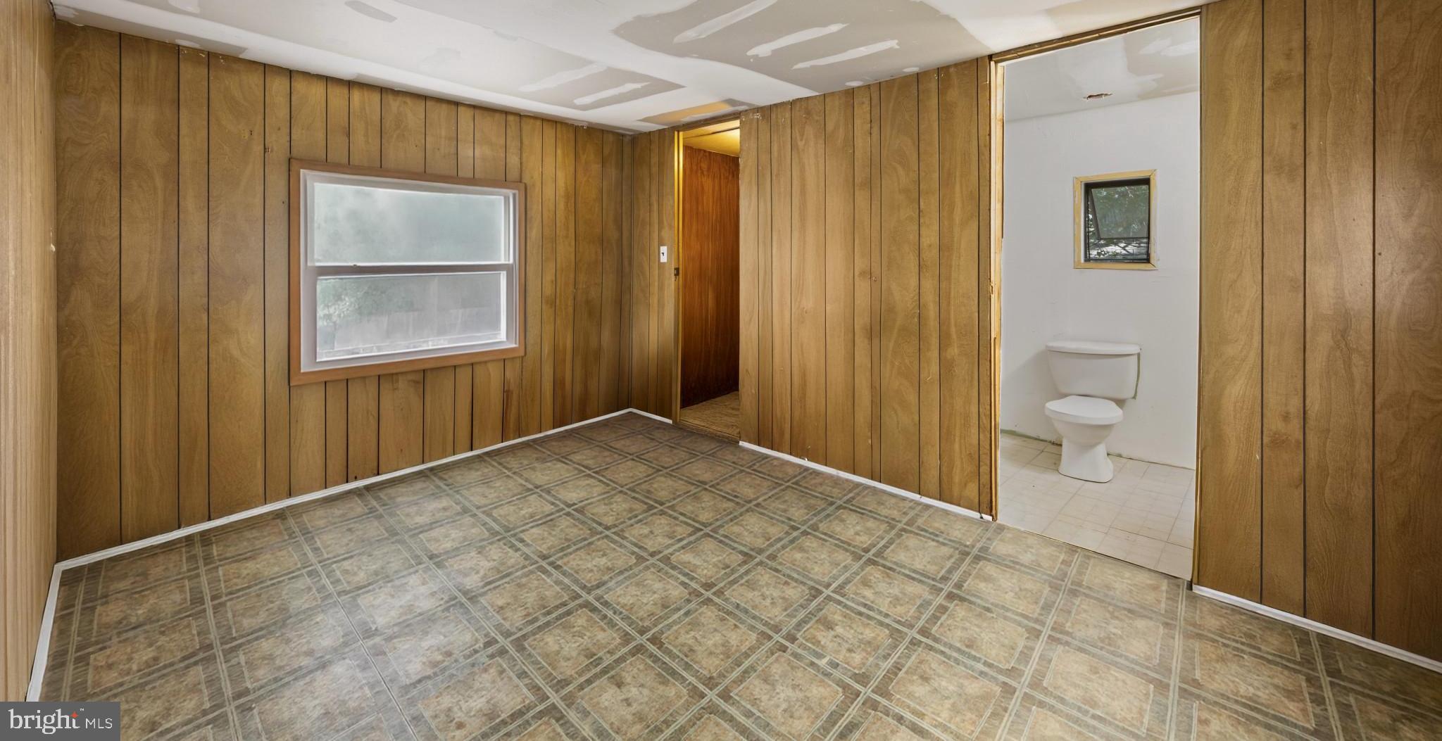 8030 Keeton Road Elkridge, MD 21075 - Photo 11 of 44 a view of a bathroom with a shower and a toilet