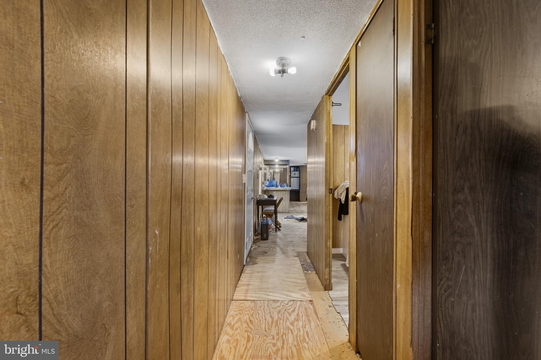 8030 Keeton Road Elkridge, MD 21075 - Photo 15 of 44 a view of a hallway with wooden shelves