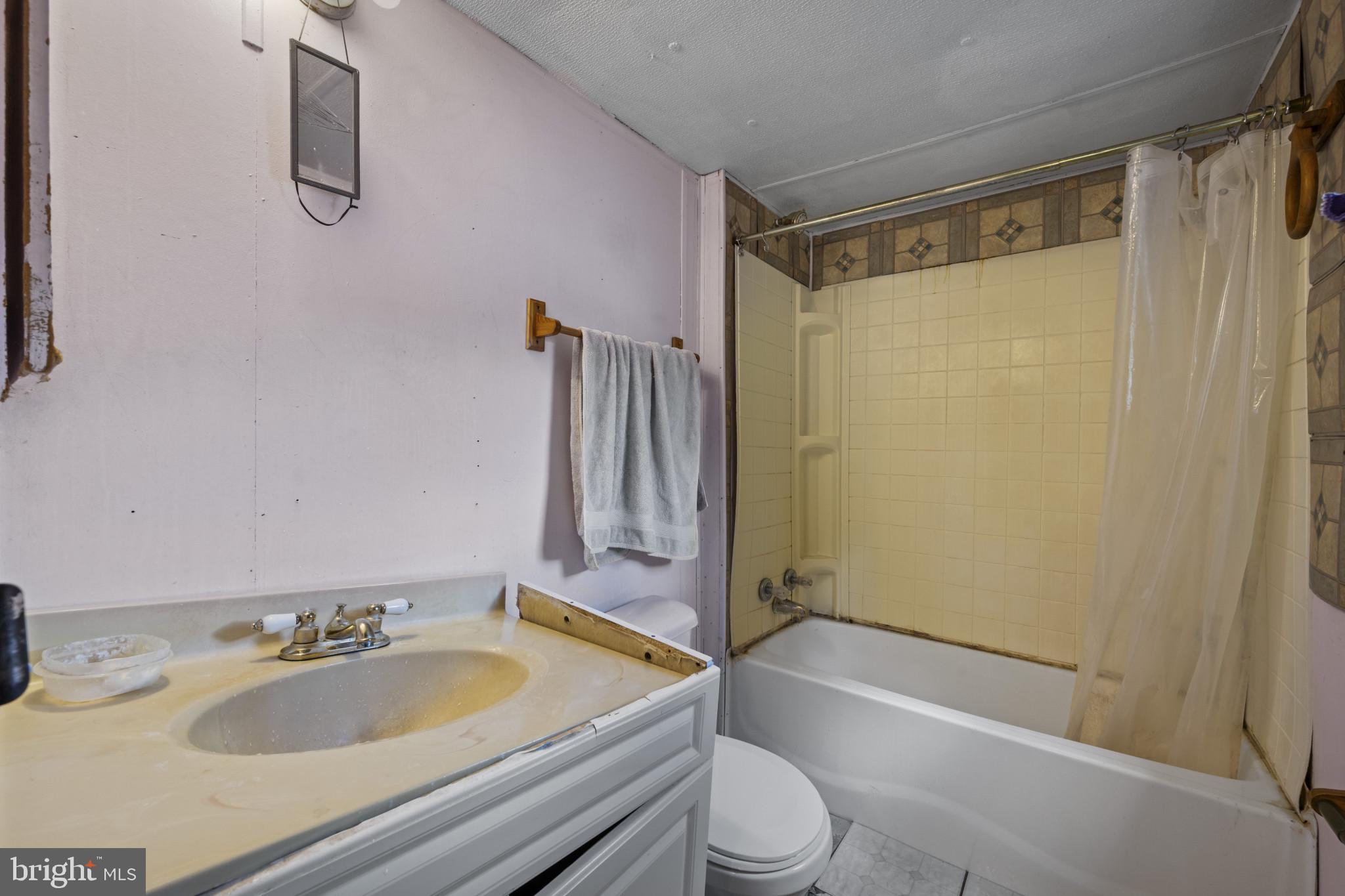 8030 Keeton Road Elkridge, MD 21075 - Photo 20 of 44 a bathroom with a granite countertop sink toilet and shower