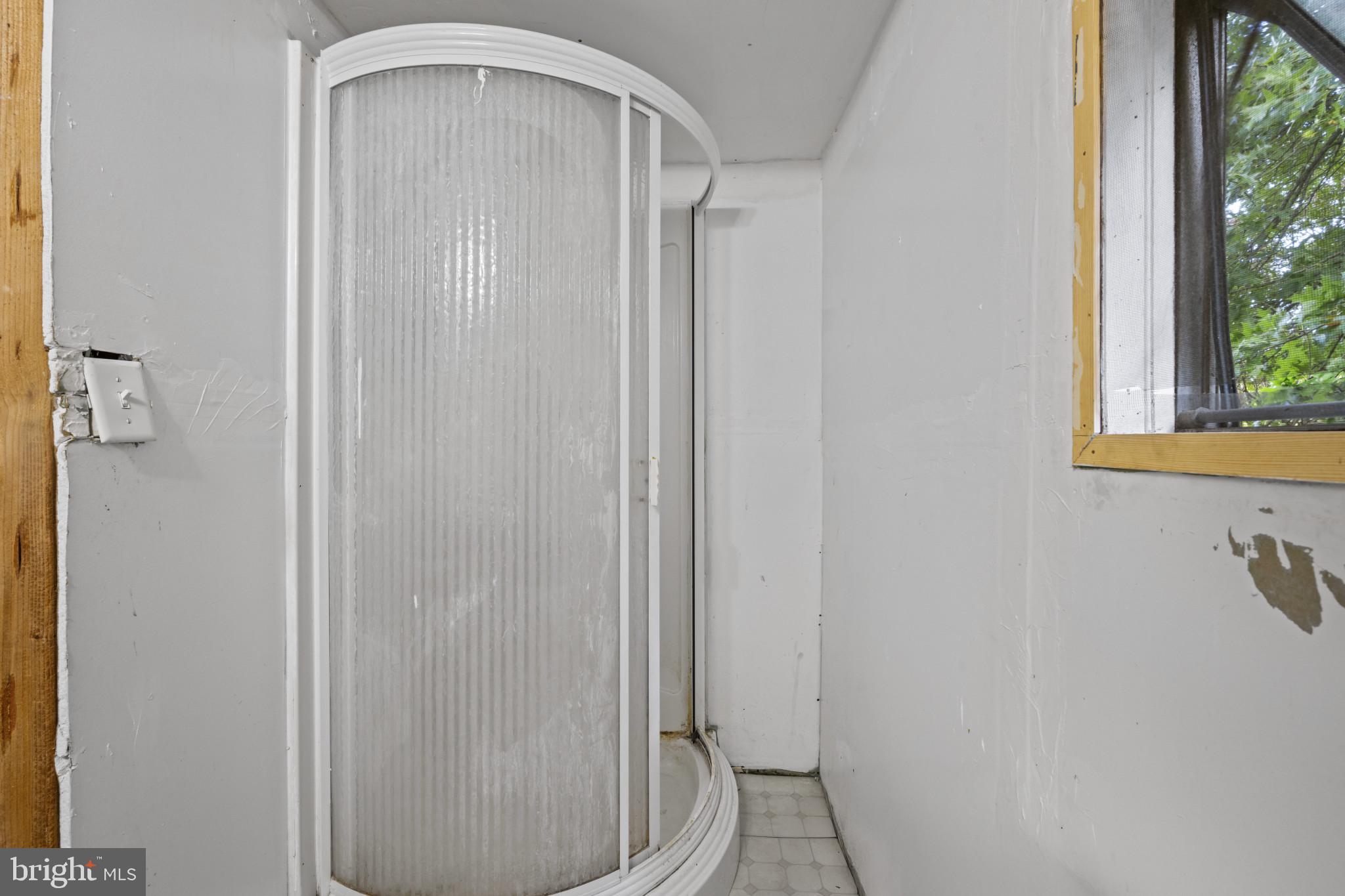 8030 Keeton Road Elkridge, MD 21075 - Photo 30 of 44 a bathroom with a glass shower door