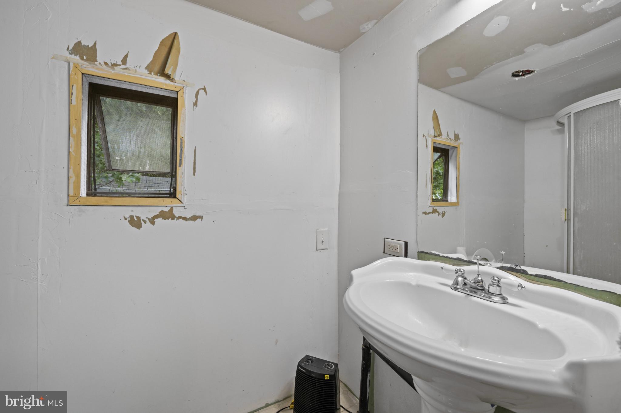 8030 Keeton Road Elkridge, MD 21075 - Photo 31 of 44 a bathroom with a sink and a mirror