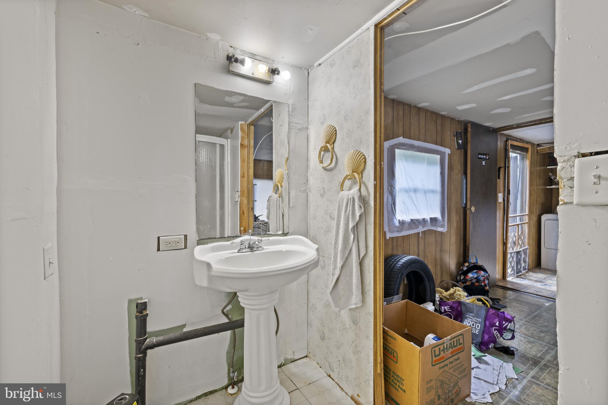 8030 Keeton Road Elkridge, MD 21075 - Photo 32 of 44 a bathroom with a sink mirror and tub