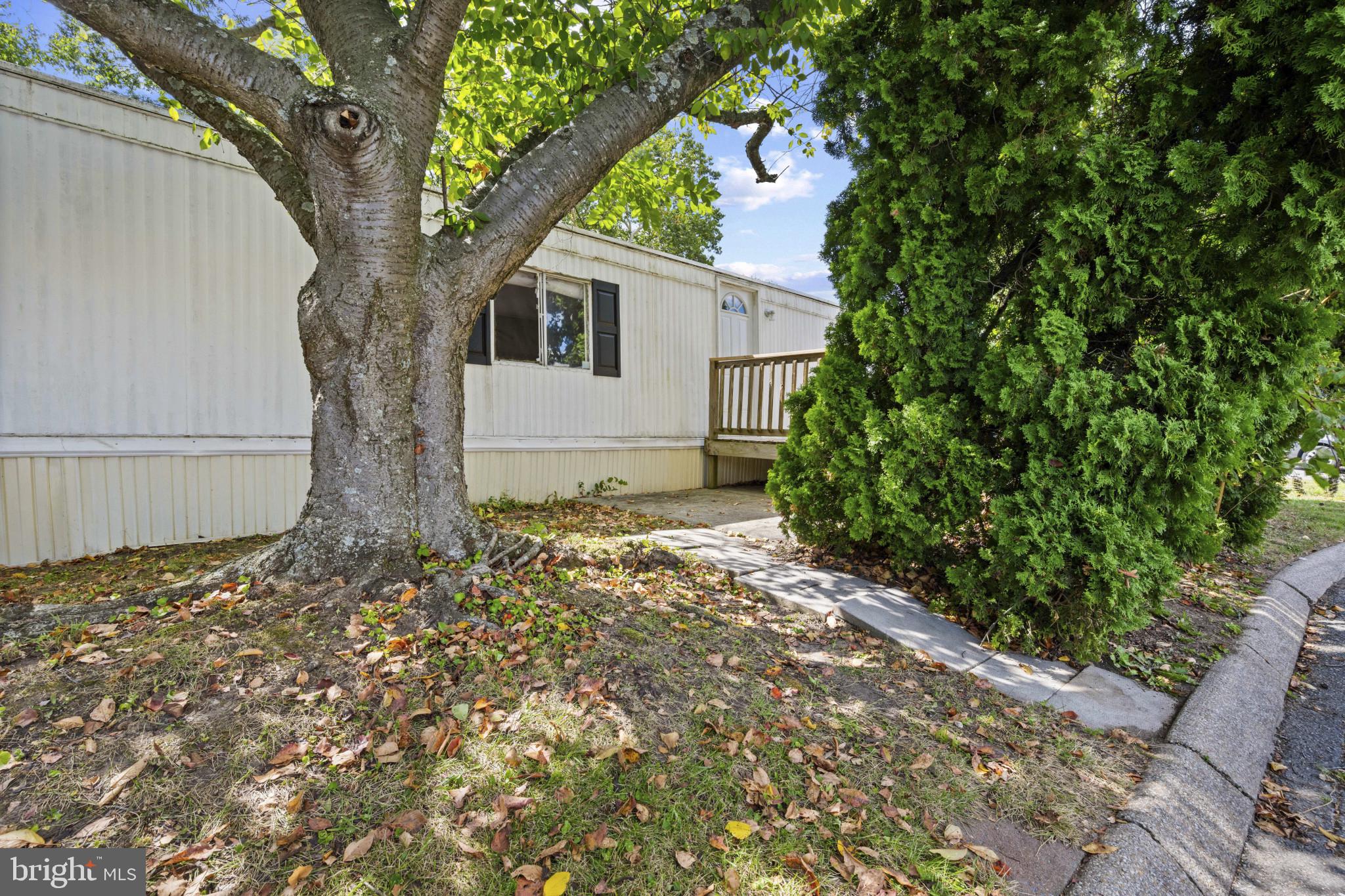 8030 Keeton Road Elkridge, MD 21075 - Photo 44 of 44 a white house that has a tree in front of it