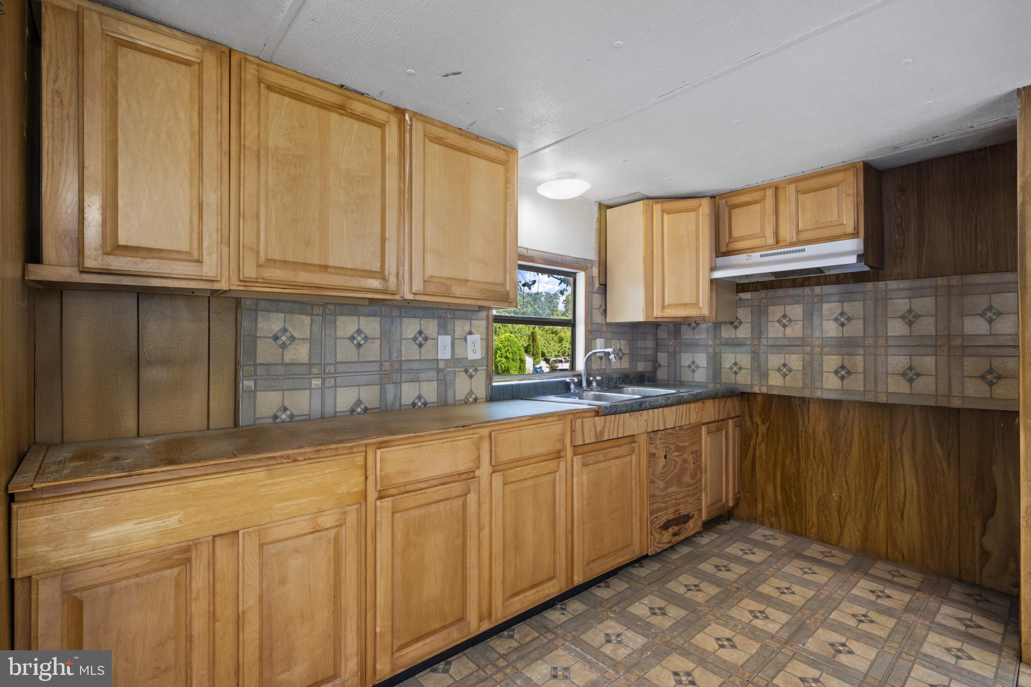 8030 Keeton Road Elkridge, MD 21075 - Photo 6 of 44 a kitchen with stainless steel appliances granite countertop a sink and cabinets