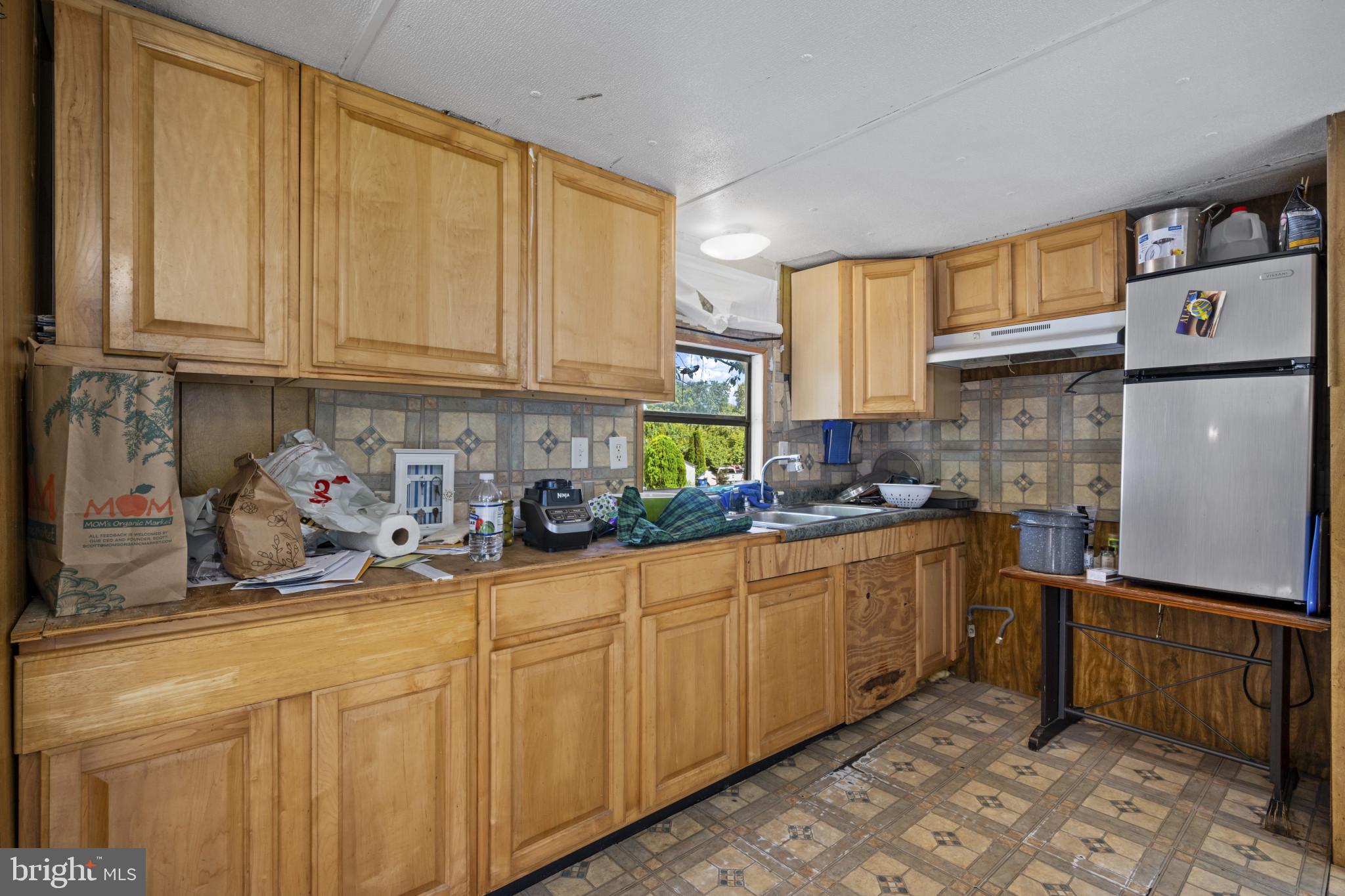 8030 Keeton Road Elkridge, MD 21075 - Photo 7 of 44 a kitchen with stainless steel appliances granite countertop a sink refrigerator and cabinets