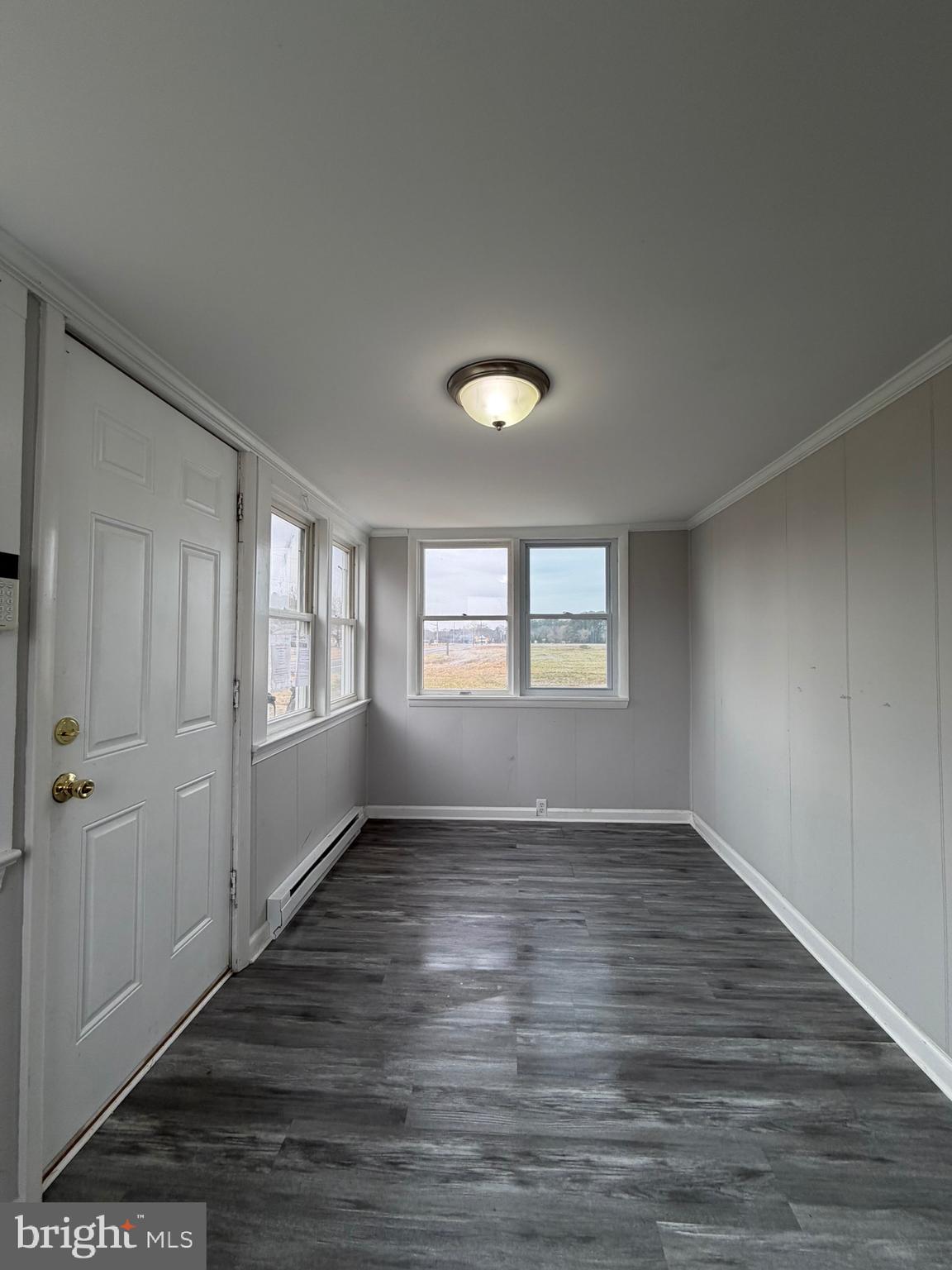 35534 Mt Hermon Road Pittsville, MD 21850 - Photo 11 of 52 a view of an empty room with wooden floor and a window