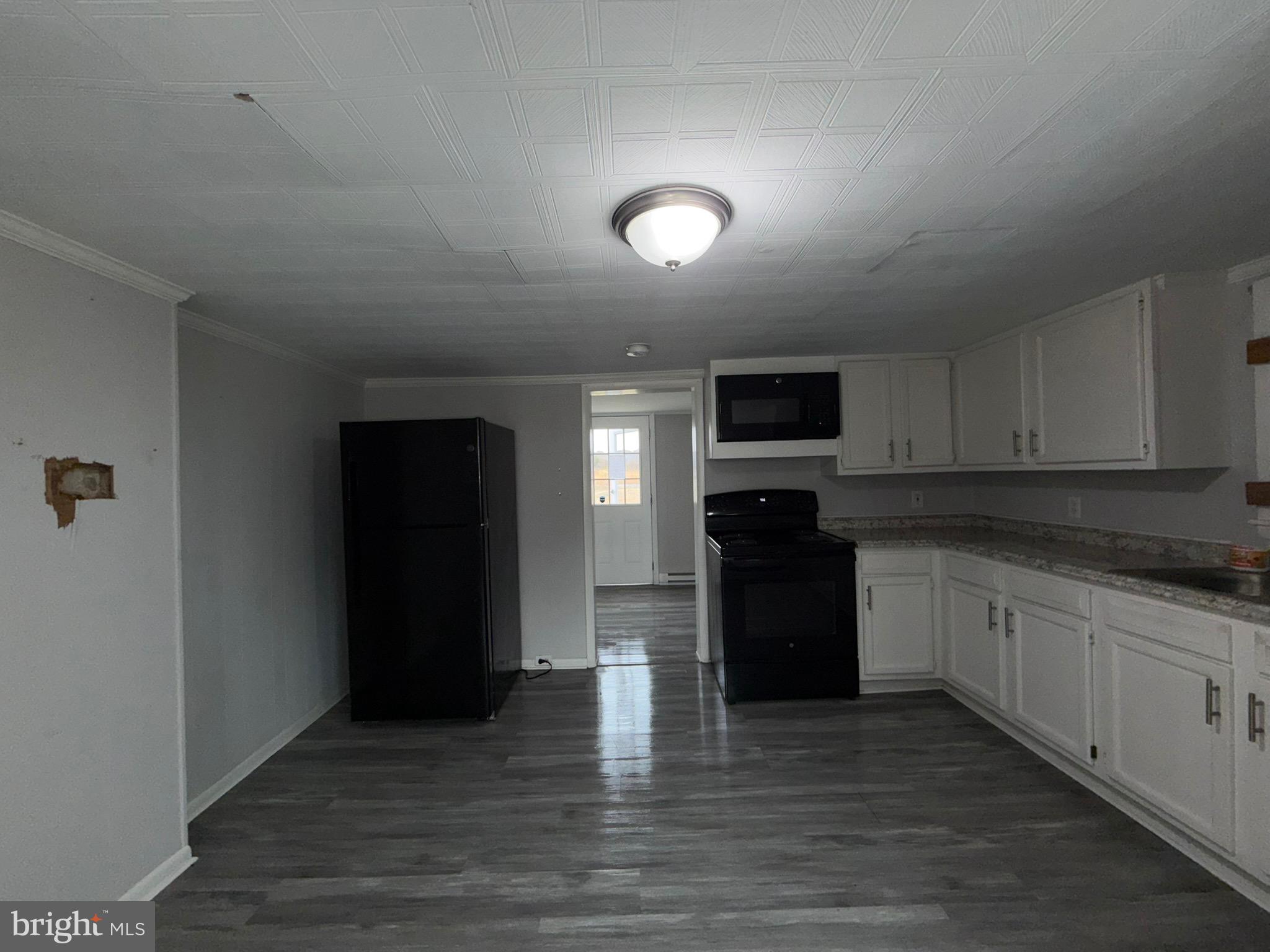 35534 Mt Hermon Road Pittsville, MD 21850 - Photo 17 of 52 a kitchen with a refrigerator and a stove top oven
