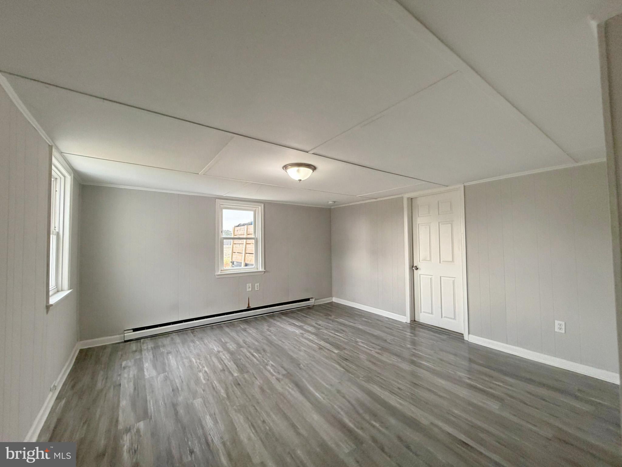 35534 Mt Hermon Road Pittsville, MD 21850 - Photo 20 of 52 a view of an empty room with wooden floor and a window