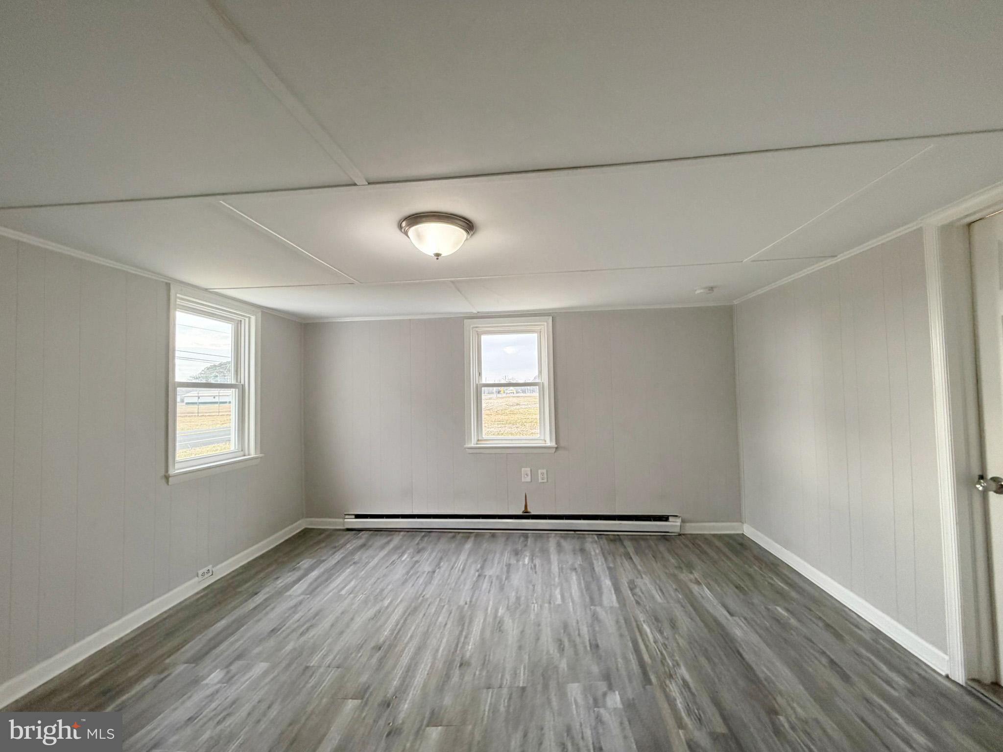 35534 Mt Hermon Road Pittsville, MD 21850 - Photo 22 of 52 an empty room with wooden floor and windows